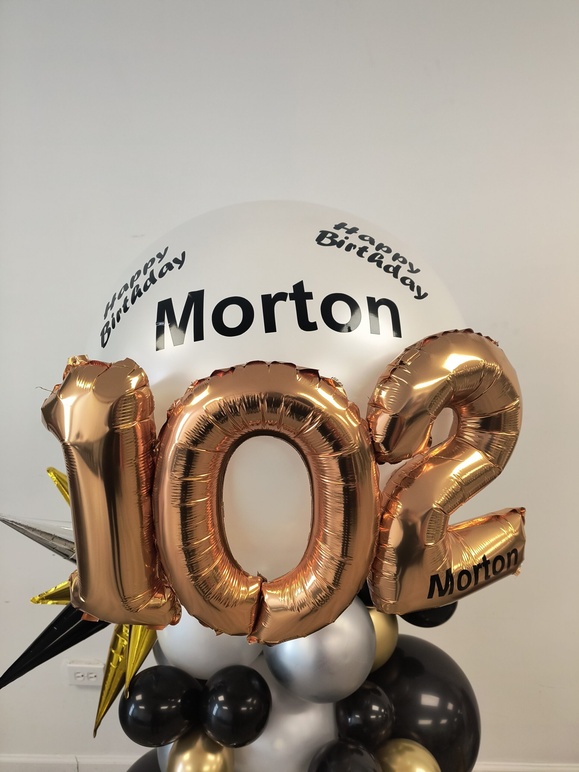 Custom balloon column with the name Morton for a 102nd birthday celebration in Knoxville.