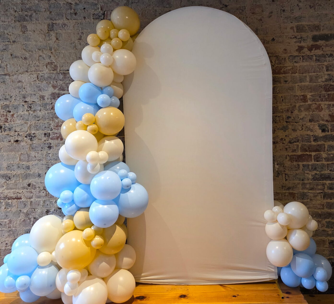 Freestanding organic balloon column in front of a backdrop for a Knoxville baby shower