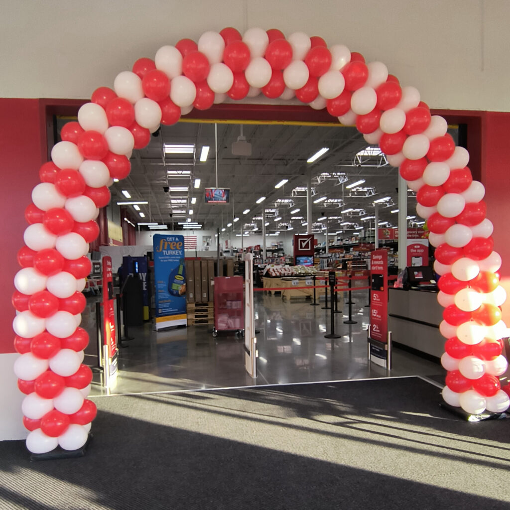Red and white spiral balloon arch at BJ's Wholesale Club entrance in Sevierville TN